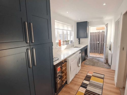a white and dark blue utility room