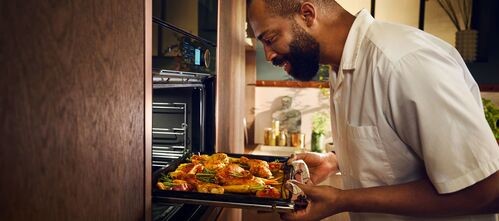 A person looking into a NEFF oven