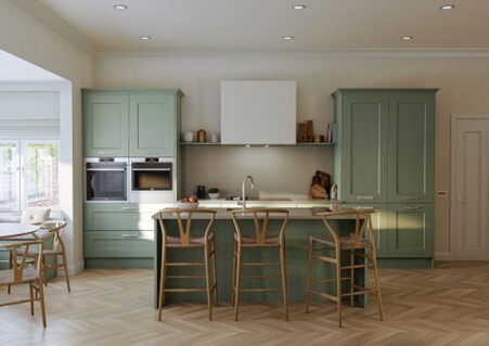 Sage green kitchen with wooden breakfast bar and herringbone flooring