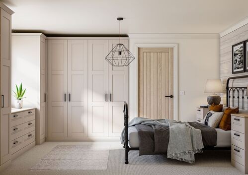 Light gray bedroom with built-in wardrobes and black metal bed frame