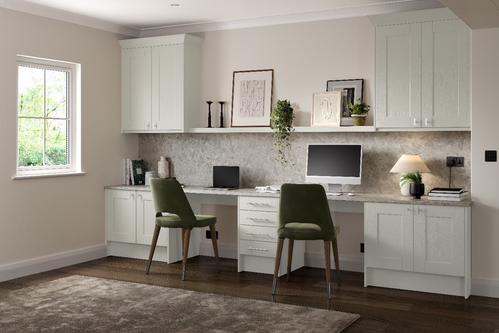 White home office with green chairs and marble-effect backsplash