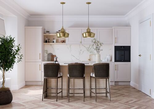 White kitchen with marble backsplash, brass pendants, and velvet barstools
