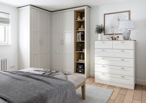 Built-in white wardrobe and storage solutions in modern bedroom