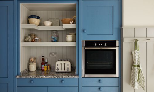 Close up image of a kitchen storage unit with an integrated oven appliance.