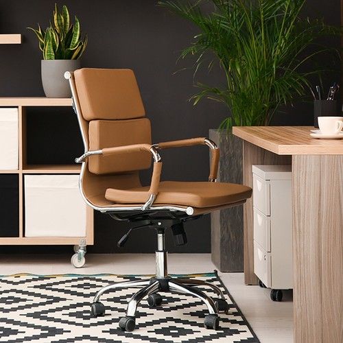 Image of a modern home office design with wooden furniture and a leather office chair.