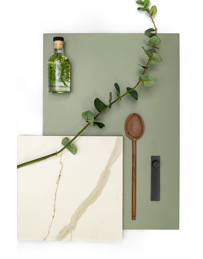 Minimalist flatlay with eucalyptus branch, wooden spoon and glass bottle on sage background