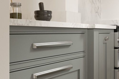 A shaker kitchen with modern metallic handles