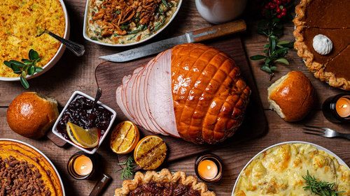 Image of a Christmas Dinner with ham, pies, and rolls
