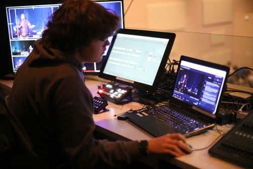 FCC member serving in the tech booth during Sunday service 