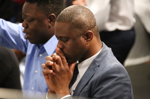 two men praying in church