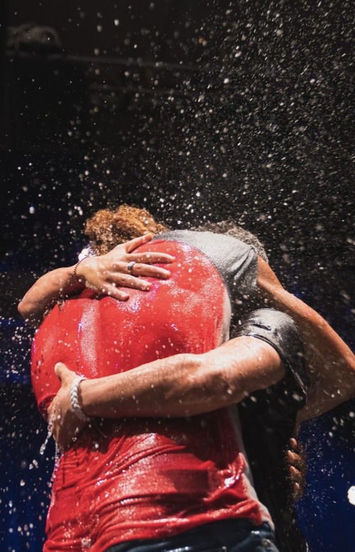 a person lifting another woman