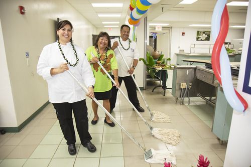 three chefs mopping the floor