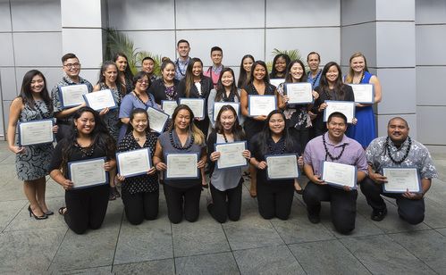 group of students holding certificates