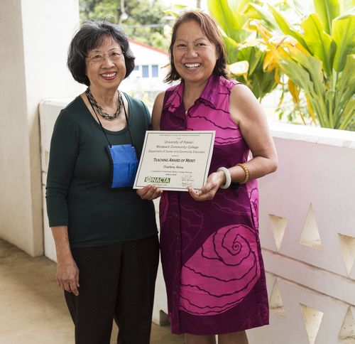 two women receiving an award