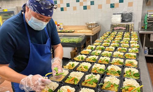 man preparing take out meals
