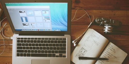 laptop and notebook and pen on desk