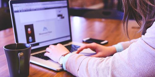 female on a laptop on desk