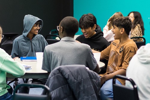 Group of people holding ice pops and smiling