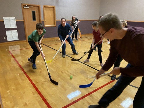 youth playing hockey in our gym
