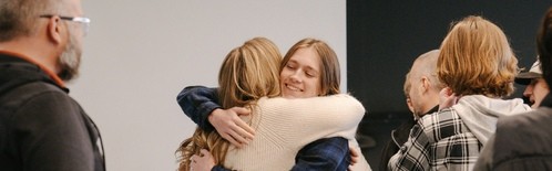 people hugging and greeting in foyer