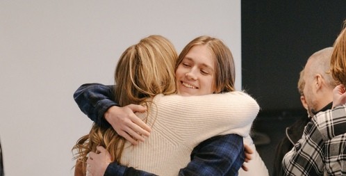 people hugging and greeting in foyer