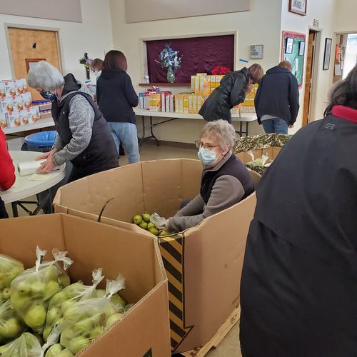 an image of volunteers packaging fresh food