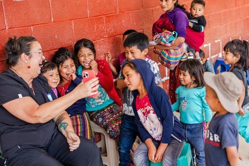 Liberty Church missionary playing with local Guatemalan kids at a Agua Viva feeding center.