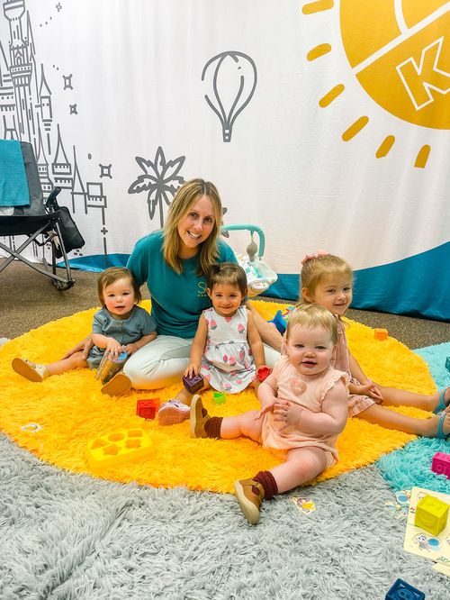 babies smiling with a volunteer
