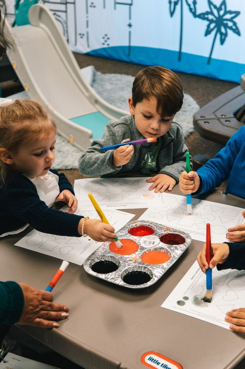 preschoolers painting in class