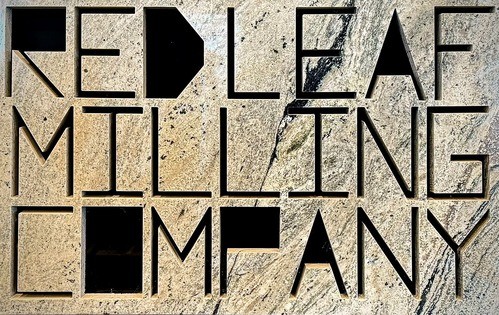 Sign for Red Leaf Milling Company carved into a textured stone surface