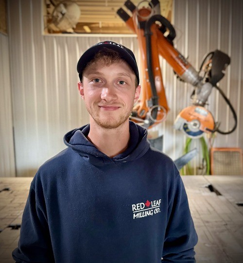 Johnny Wekenman, stone fabricator, standing infront of stone cutting robot.