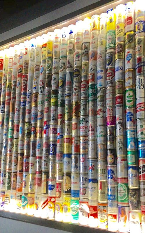 Image of David Sloan's legendary beer collection on display at Mary Ellen's