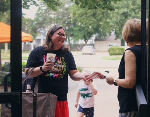 Two women greet each other outside of church.