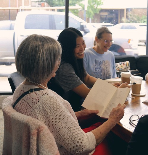 Group of women smiling during bible study.