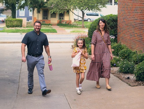 Happy family walking into church.