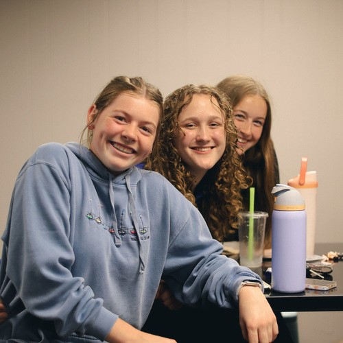 Blonde toddler boy smiling at the camera.