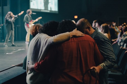 People praying together at Cornerstone Christian Church in the worship center