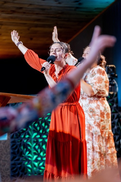 food in buffet style with people putting food on plates
