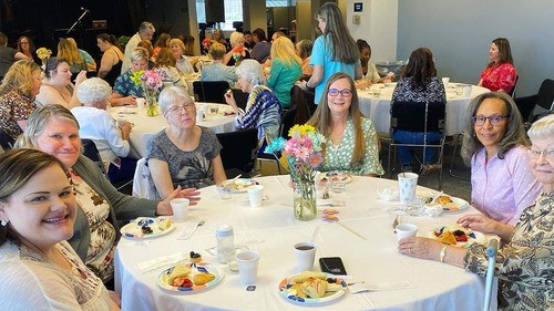 A group of women meeting around a table