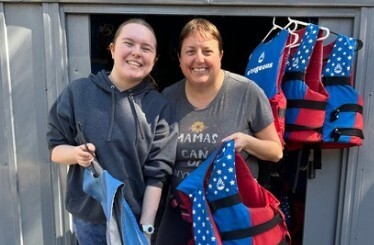 Laura and her daughter organize the life jacket shed.