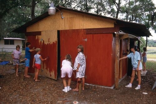 People painting old barn.