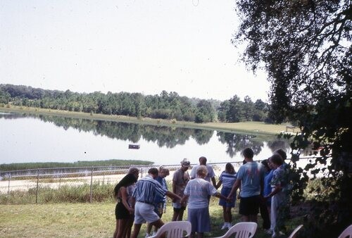 People praying next to Lake.