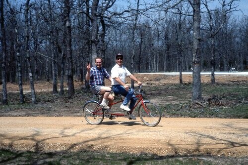 Men on a double bike.