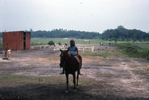 Old picture of girl on a horse.