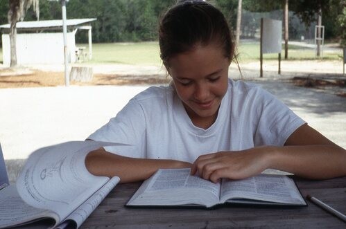 Girl reading a Bible.