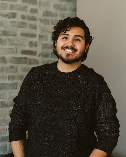 Josh and Corban posing in front of the banners for the CWC Youth group, a meet-up for teens in Colorado Springs, CO.
