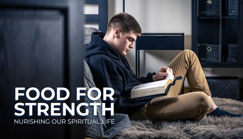 black and white photo of man studying the bible