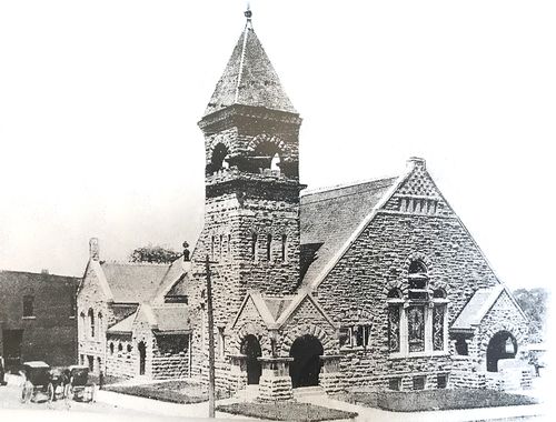 An old, black & white image of First Christian Church from the 1900s with a horse and buggy in front.