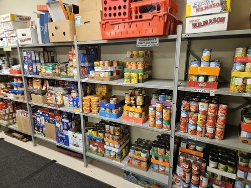 Shelves of food for the MedinaUMC Food Pantry including canned fruits and vegetables, Macaroni and cheese and other food.