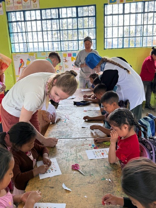 Grace Point students serving children in a classroom in Guatemala